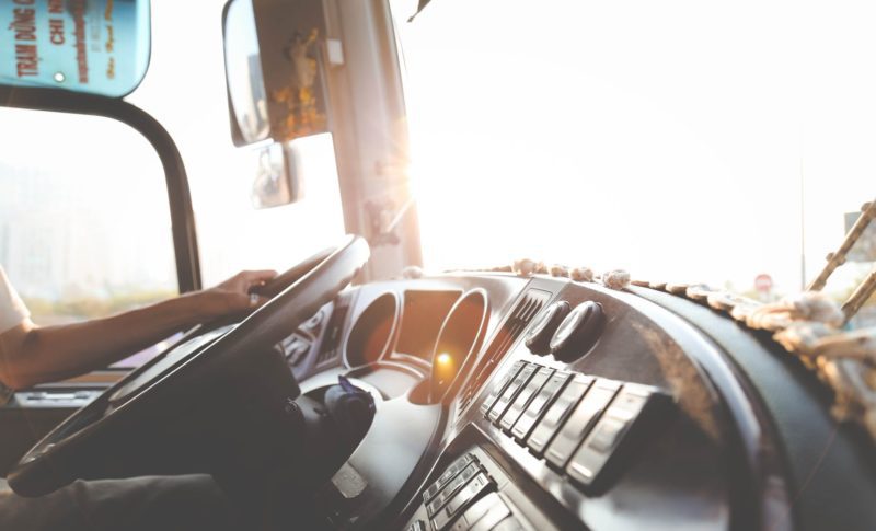 person hand on steering wheel