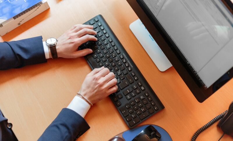 person typing on computer keyboard