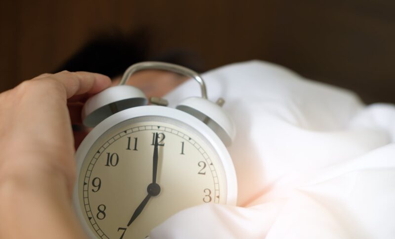 photo of person holding alarm clock