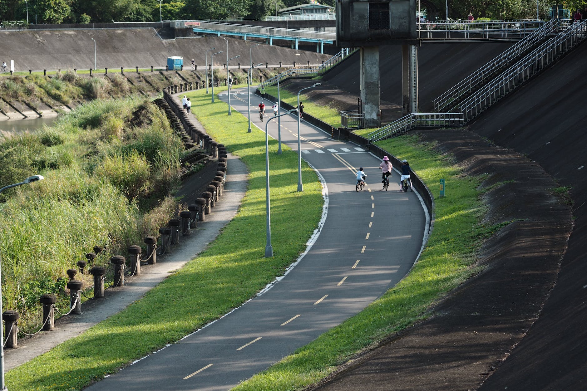 people driving on bike lane along riverba