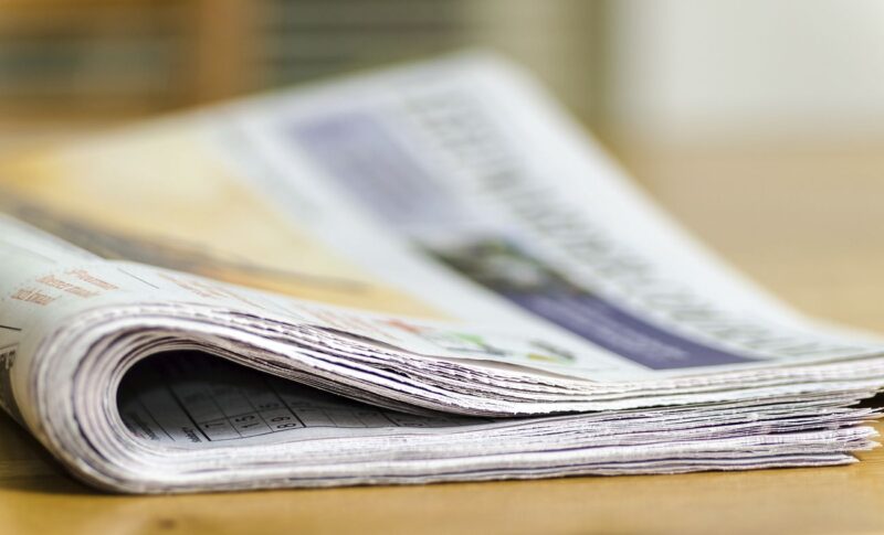 Free newspaper on table closeup